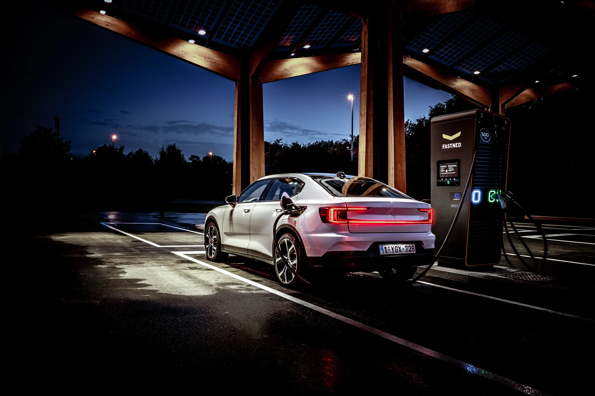 EV charging infrastructure engineered by SLC Energy Solutions, charging canopy at dusk